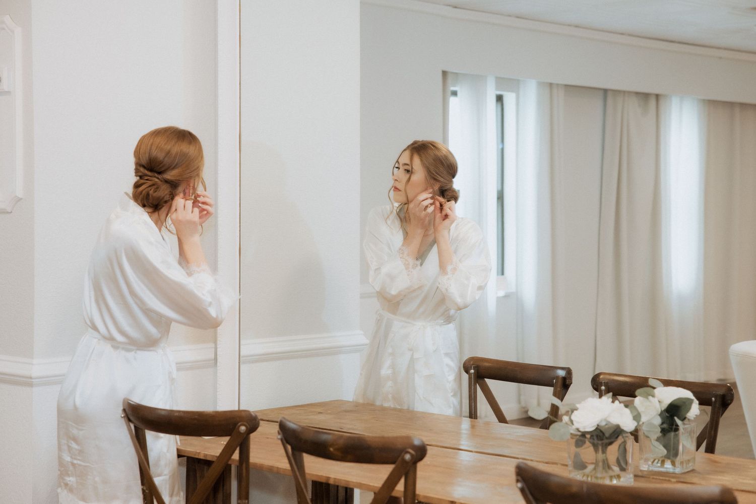 A sequence of wedding preparation photos showing bridesmaids helping with final dress adjustments in a bright room.