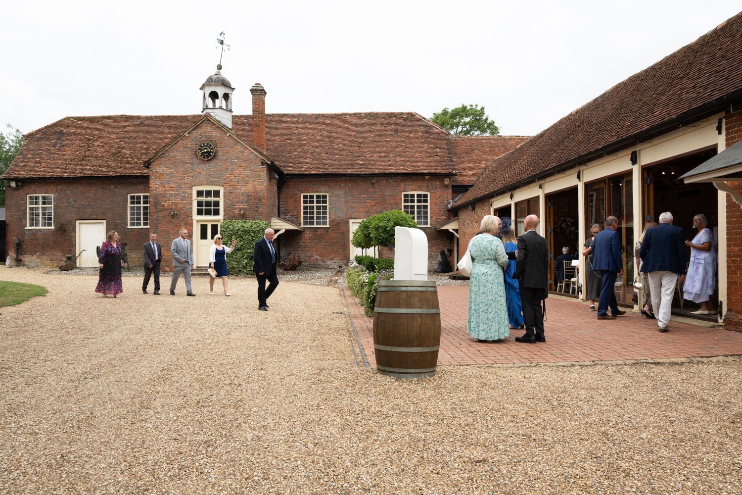 Panoramic view of a traditional brick courtyard venue with Tudor-style architecture.