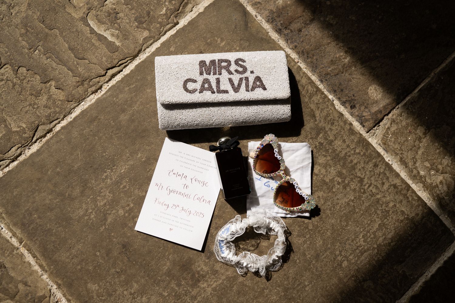 A series of torn paper notes scattered on a dark stone or concrete surface.