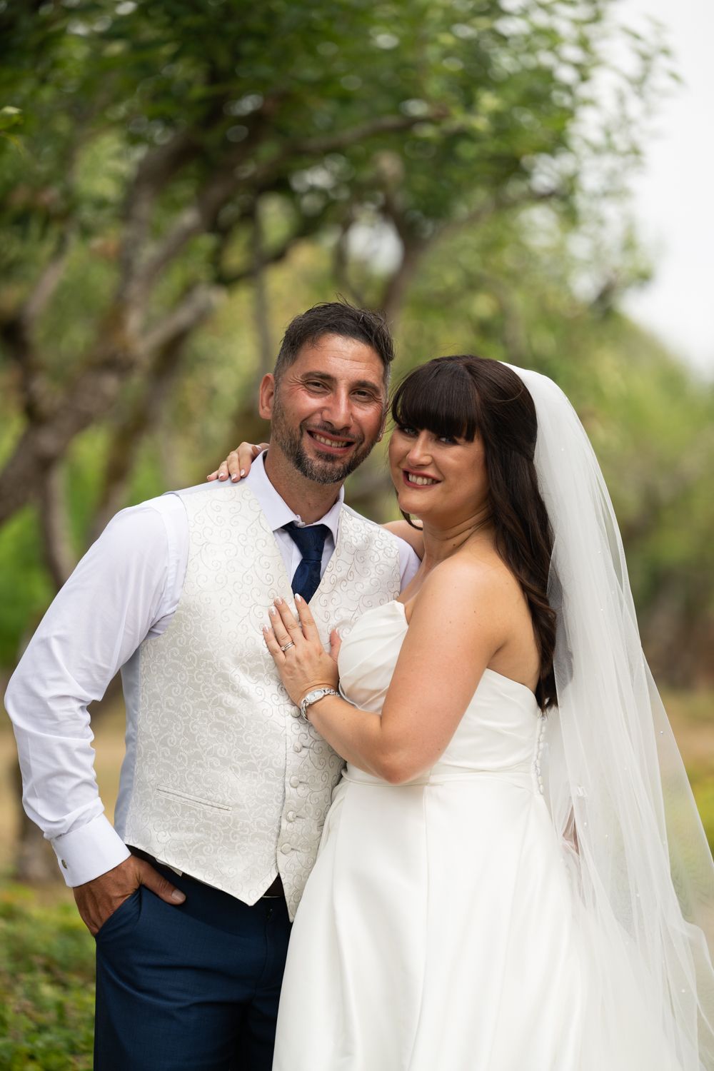 A bride and groom share joyful moments together outdoors in a series of candid wedding photos.