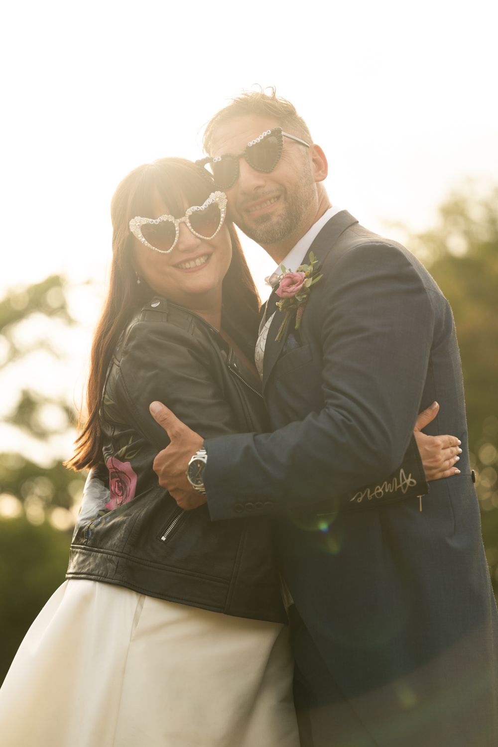 A romantic sequence of wedding photos shows a couple embracing in warm sunlight during their outdoor celebration.