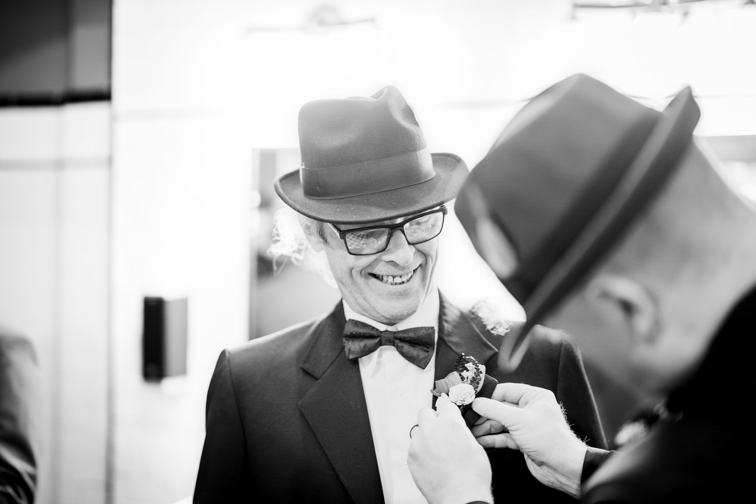 A black and white photo collage showing candid moments at a wedding celebration.