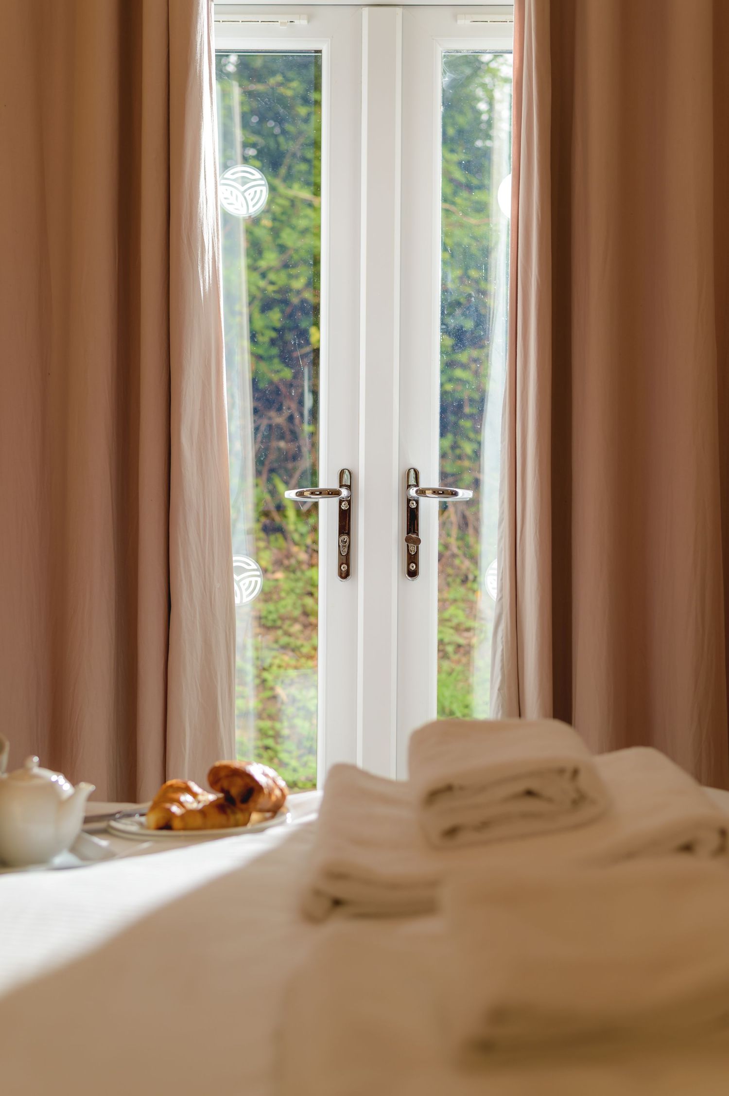 bedroom scene with morning light pouring through patio doors