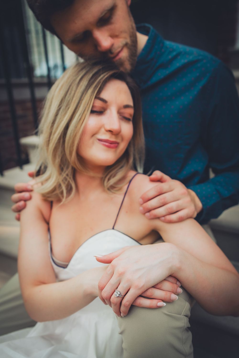 A romantic engagement photo series showing a couple's hands with a diamond ring in an outdoor urban setting.