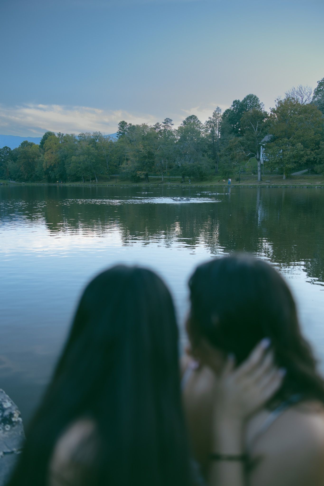LGBTQ couple holding hands after romantic proposal at blue ridge mountain overlook near Asheville, North Carolina