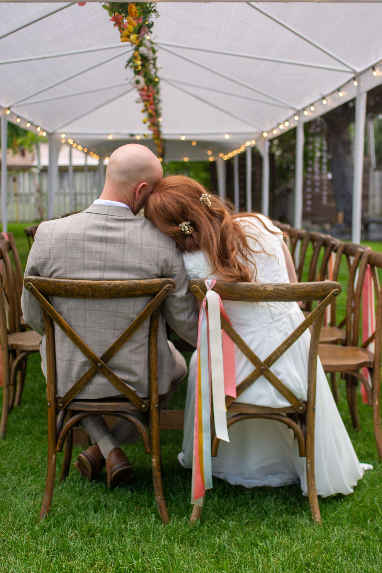 Bride and groom on wedding day sitting in Rexburg, Idaho at their backyard wedding.
