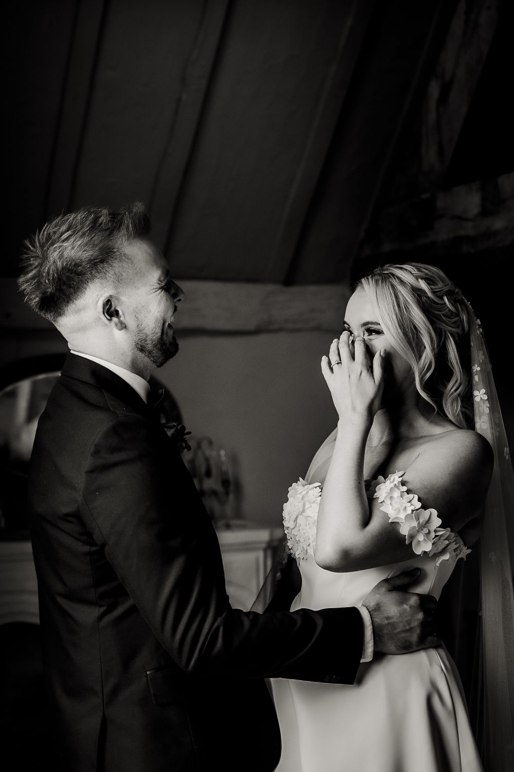 A tender black and white emotional moment shared between newlyweds during their first look.