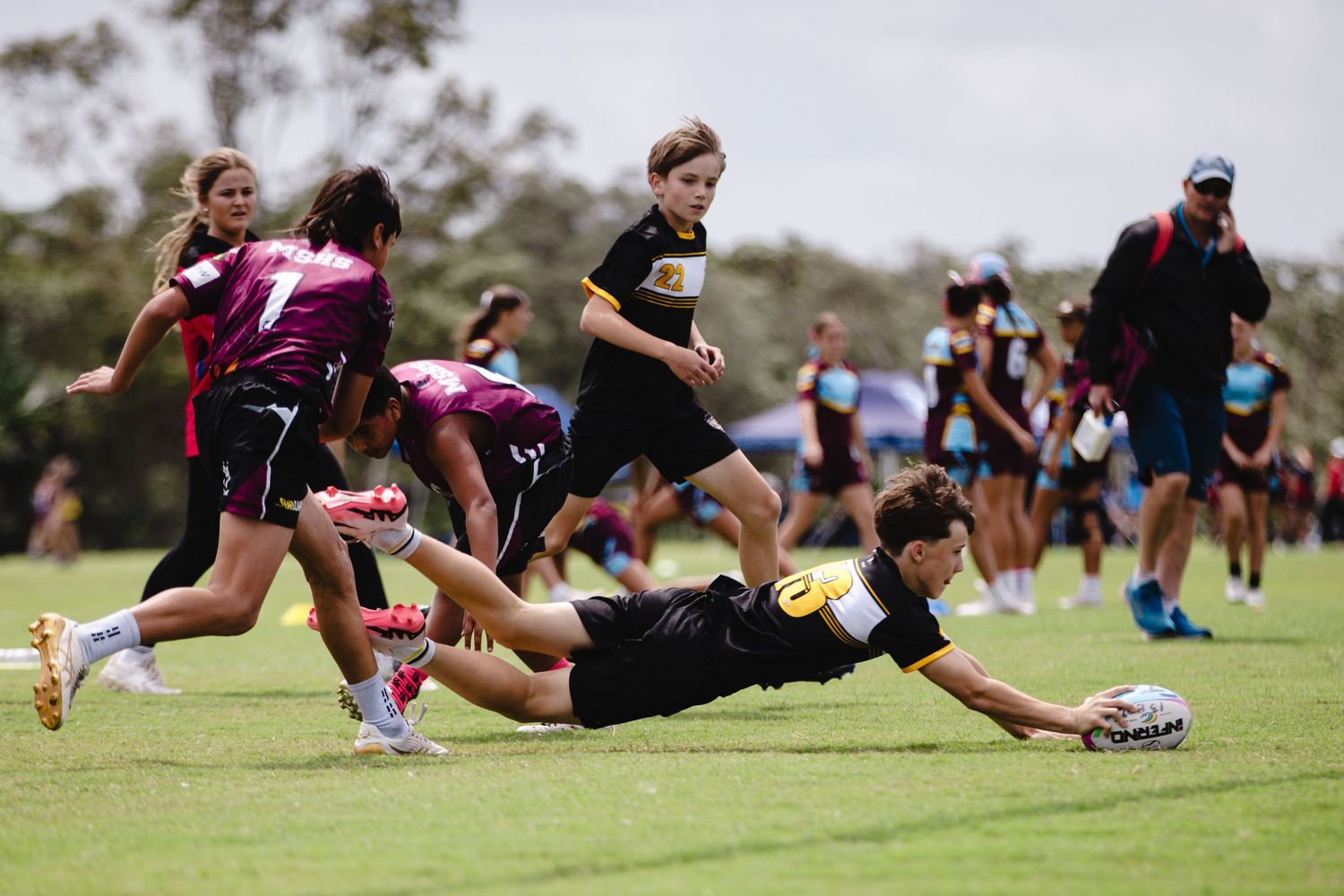 Rugby players competing in a tackle during outdoor match.