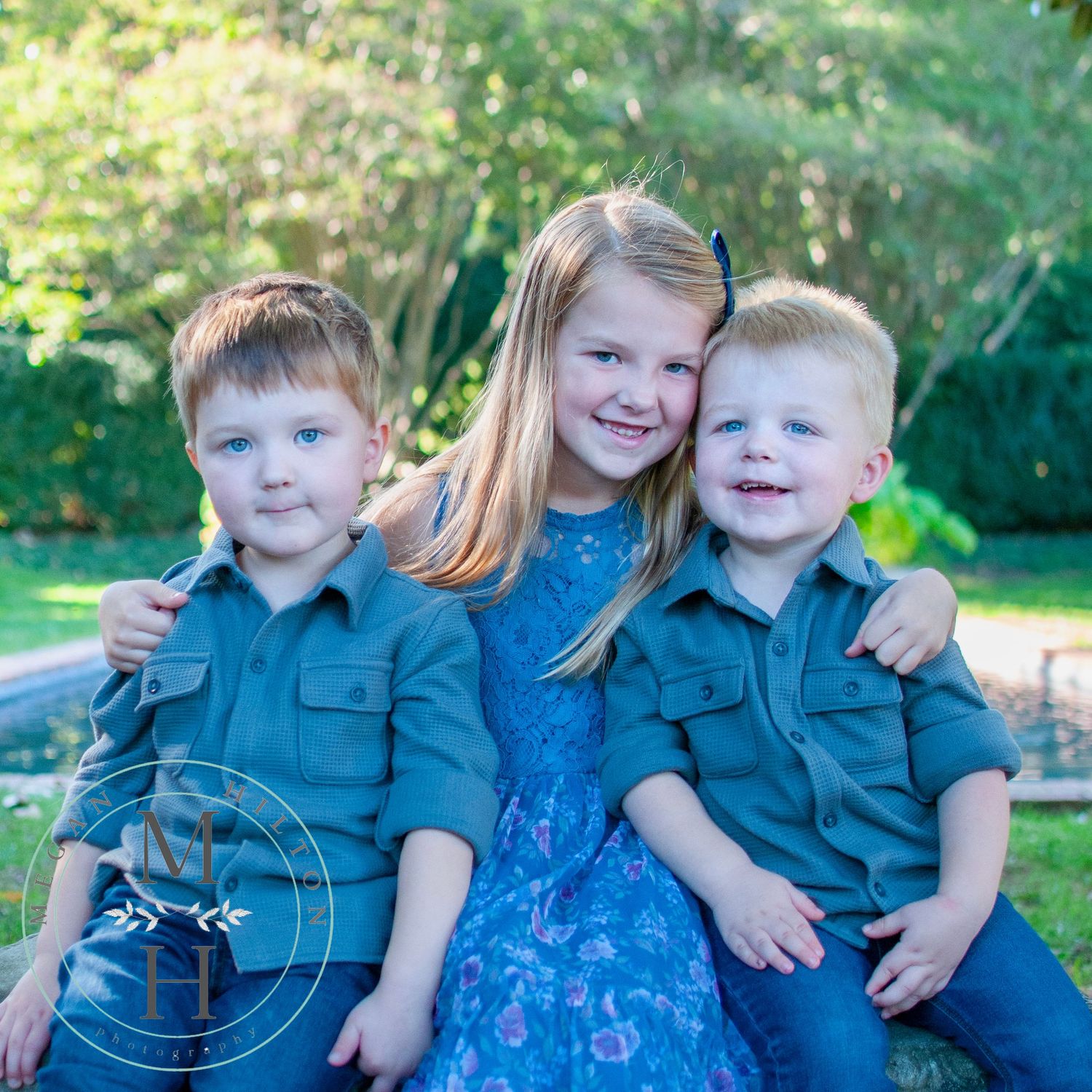 three children sitting together photo