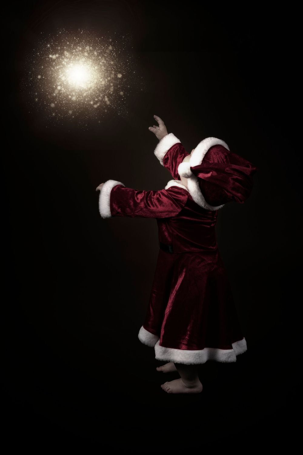 A magical Christmas scene with a Santa costume and glowing light effect.