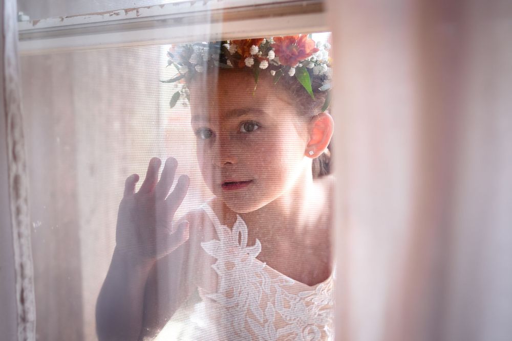 Emotional getting ready moments captured through window reflections.