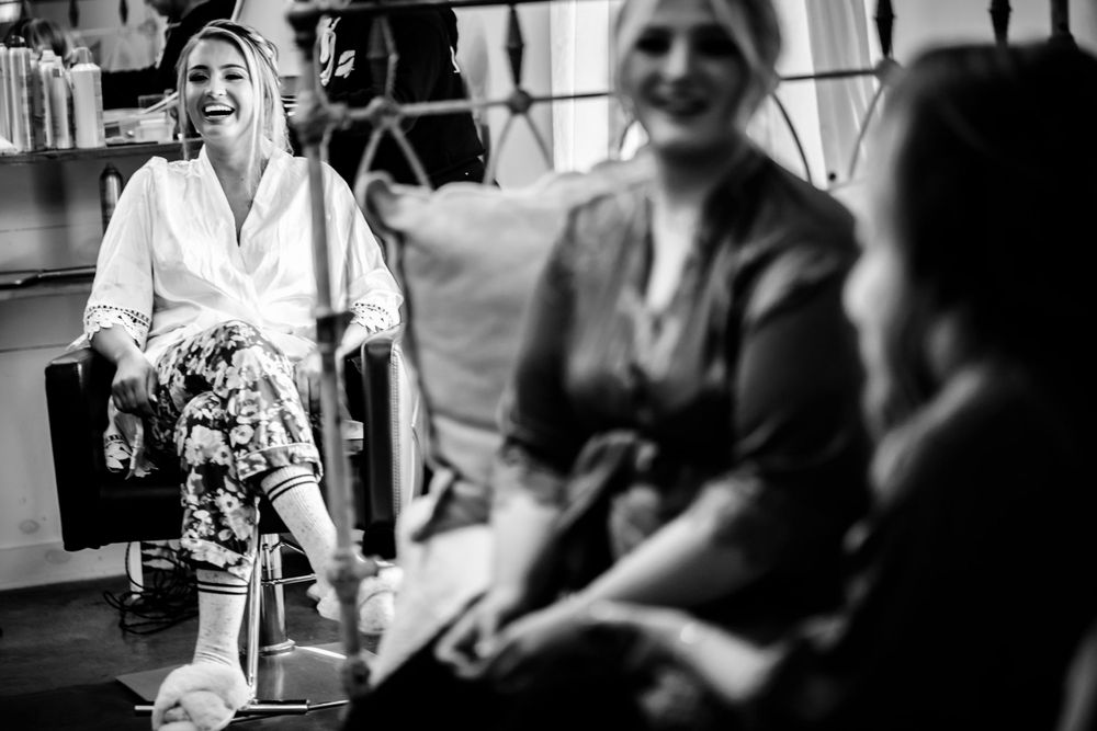 Black and white candid moments captured during wedding preparations.