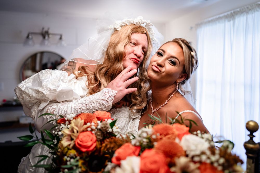 Candid wedding moment captured with floral arrangements and soft interior lighting.