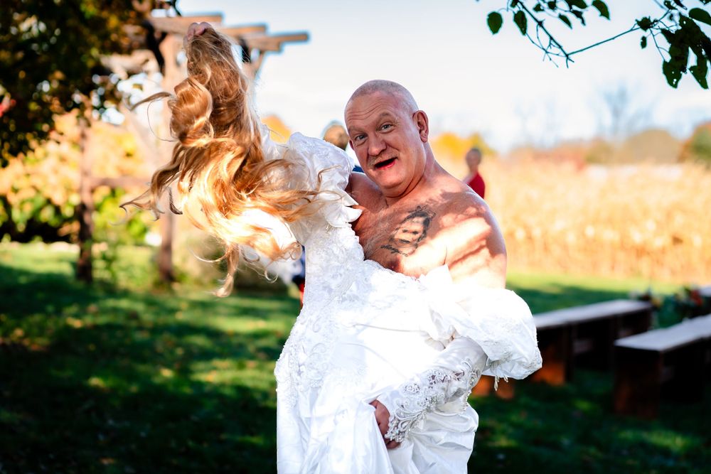 Candid wedding portraits with natural autumn scenery and joyful expressions.