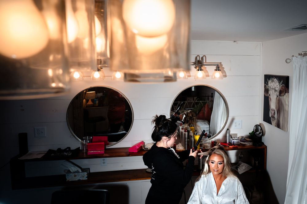 Wedding preparation scene with natural lighting in a bridal suite.