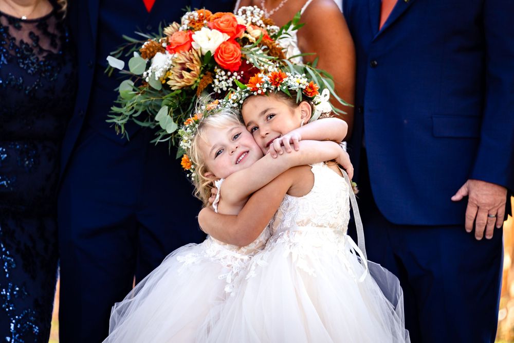 Candid moments of wedding party embracing and laughing together outdoors.
