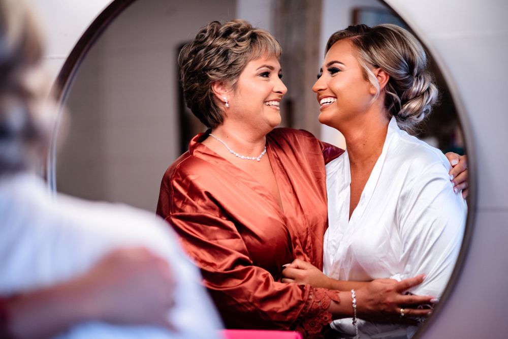 Intimate moments shared during wedding day preparations in a bridal suite.