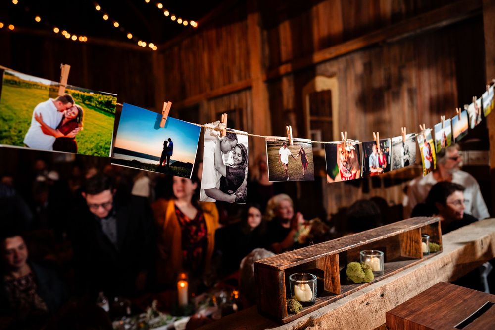 String of vintage photos displayed on twine with clothespins at wedding reception.