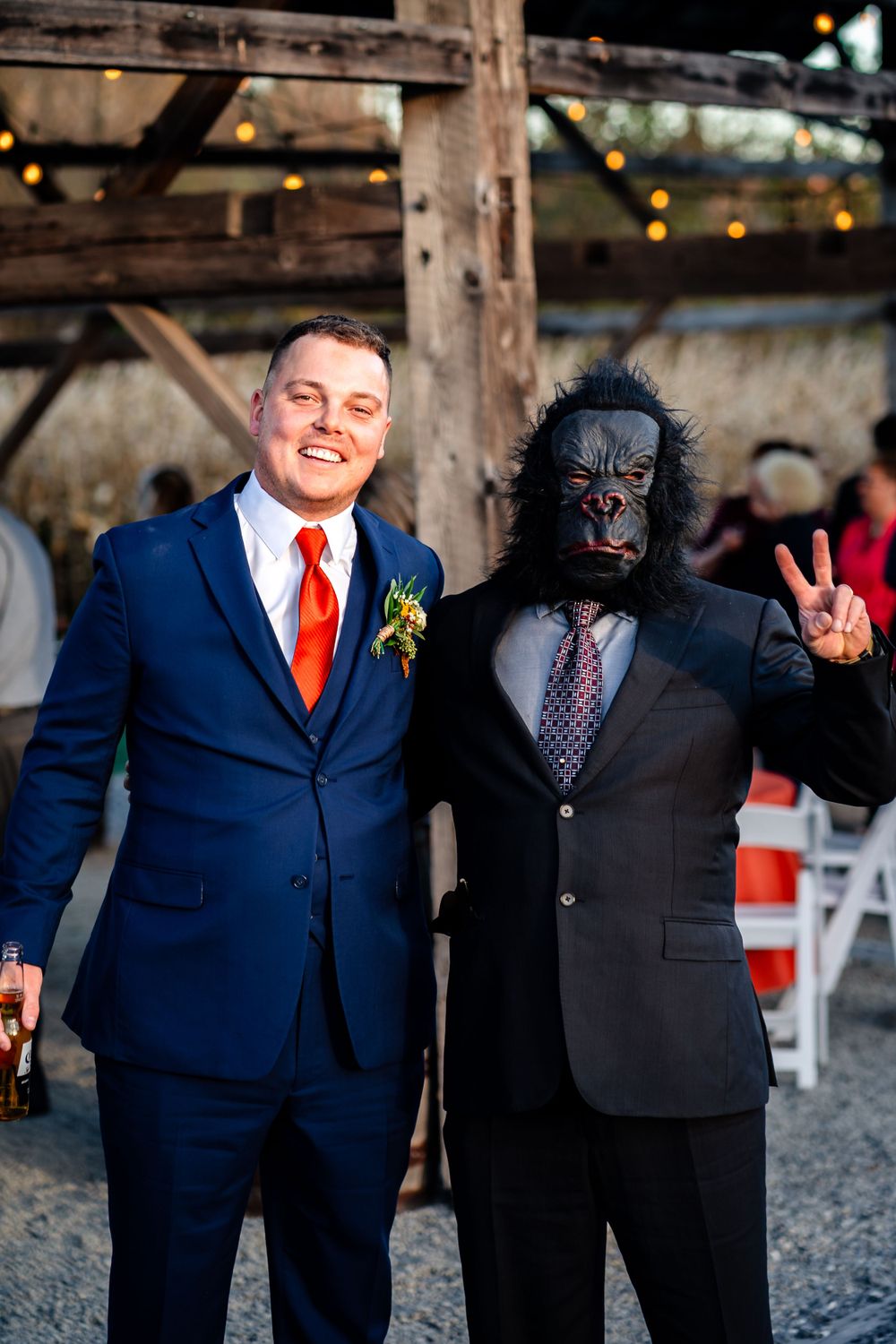Wedding party in navy suits and red ties posing for fun group photos.