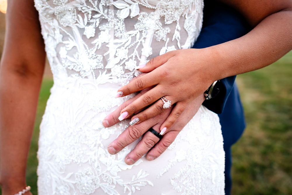 Close-up details of intricate white lace wedding dress bodice.