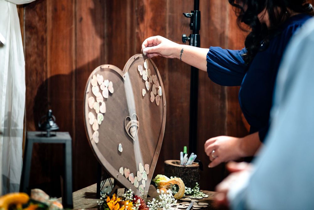 Decorative heart-shaped wedding decor piece displayed on rustic wooden table.
