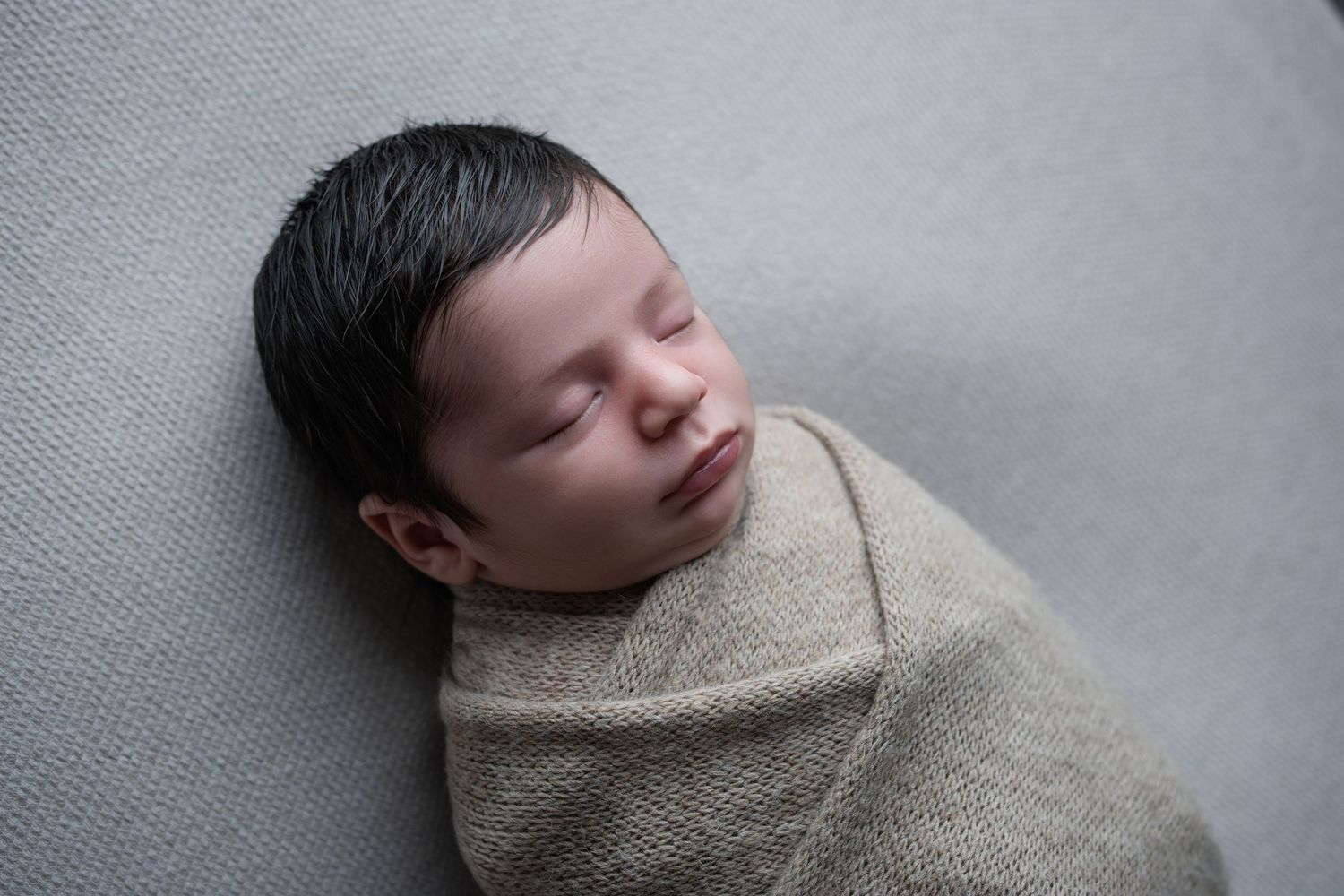 Wrapped newborn baby portrait — in-home newborn photography near Devizes