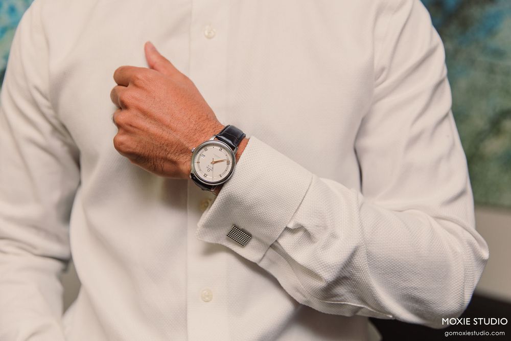 Close-up shots of a wristwatch and white dress shirt sleeve details.