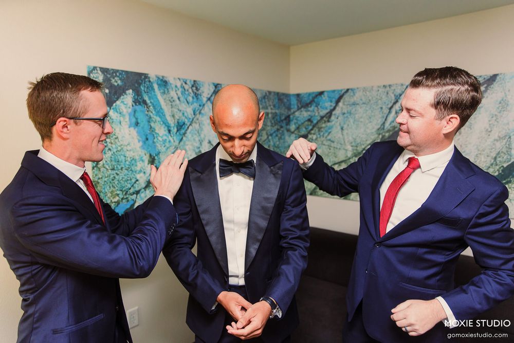 Groomsmen in navy suits playfully pose in a sequence of fun group photos.