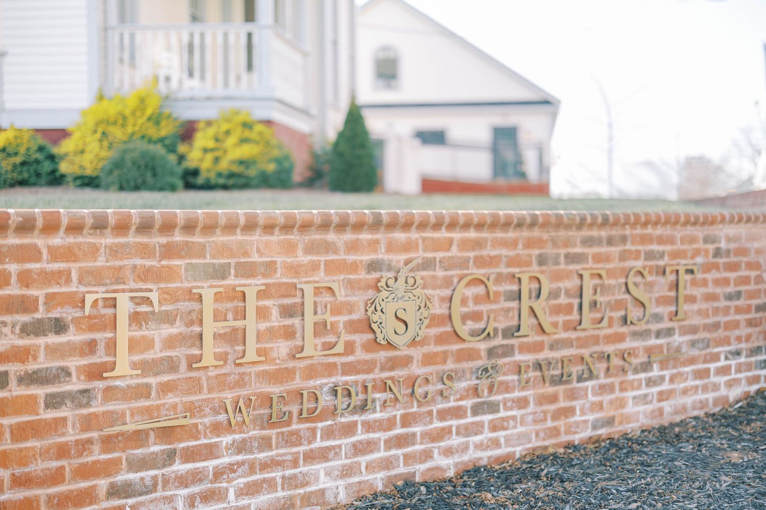 A brick wall with the word 'Christ' engraved in stone at a church or religious building.