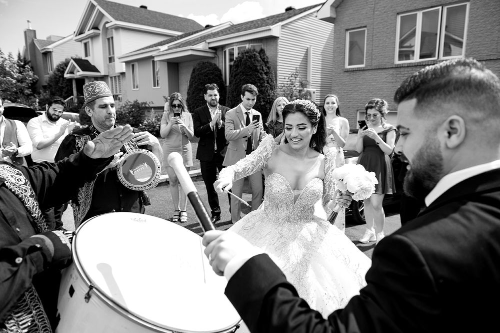 Black and white photos showing a wedding celebration with guests gathered outdoors.