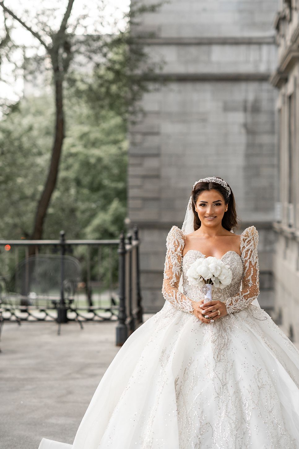 Elegant bridal portrait series showcasing a luxurious white princess wedding gown with detailed lace sleeves.