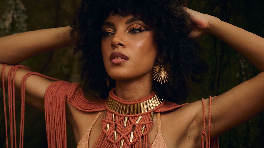 Artistic beauty portrait series featuring dramatic lighting, rich earth tones, and elegant gold jewelry against dark backgrounds.