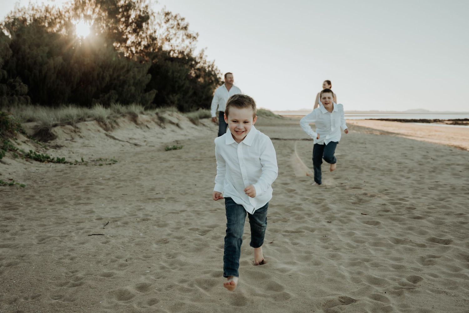A series of candid beach photos showing people walking and playing in the sand during golden hour at sunset.