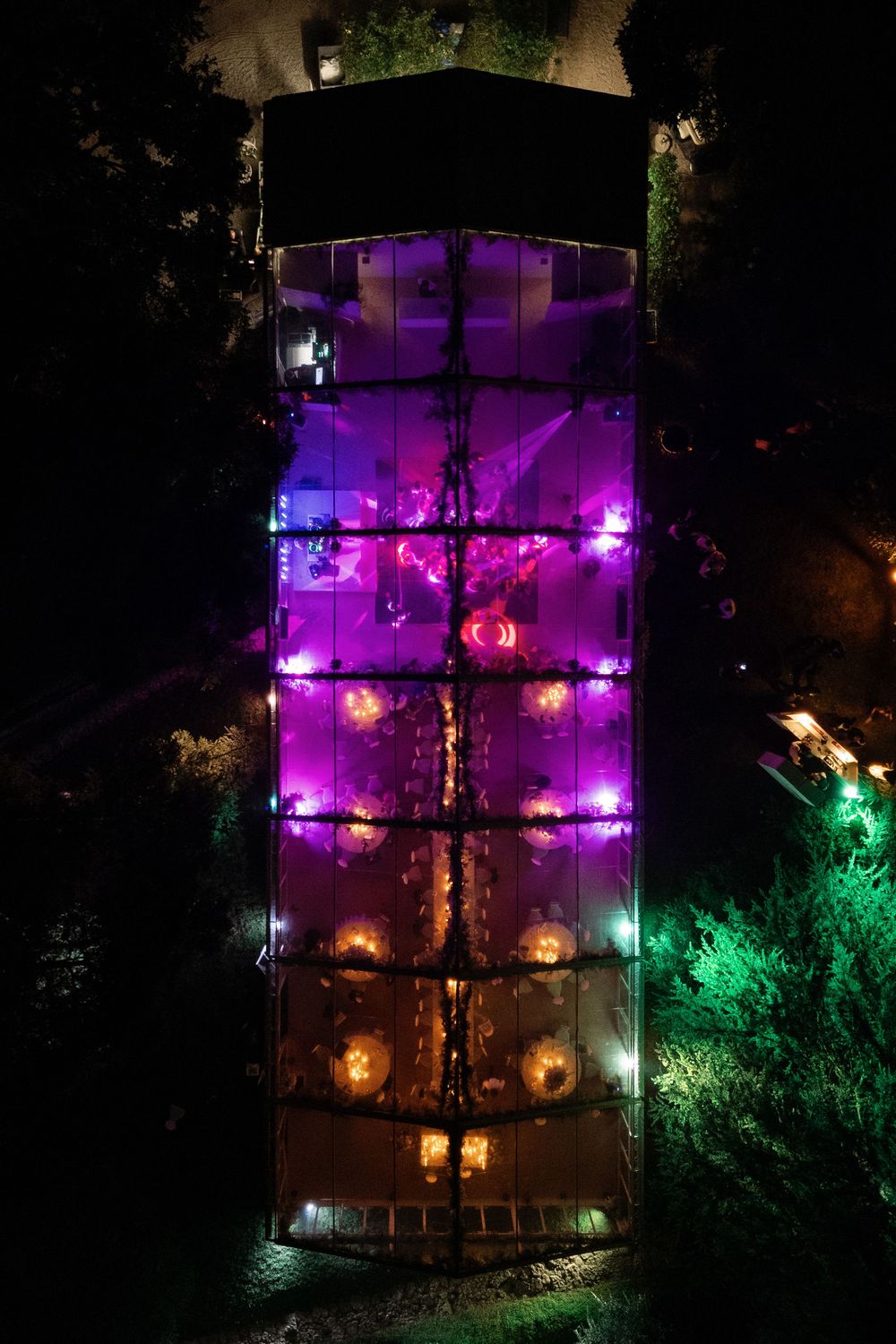 Aerial view of the wedding marquee at Isola del Garda, illuminated at night during the dance party