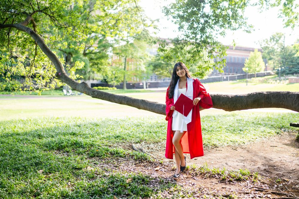 Red and white outfits create striking contrast against a natural green outdoor setting.