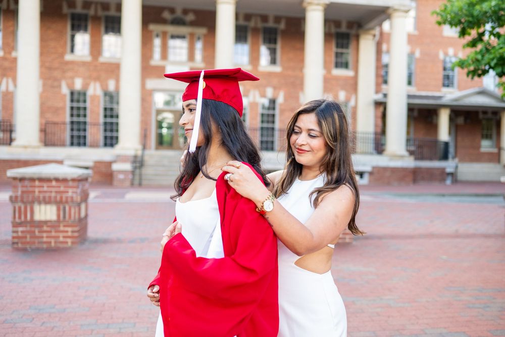 Graduation portraits captured on brick campus courtyard with red dress and heels.