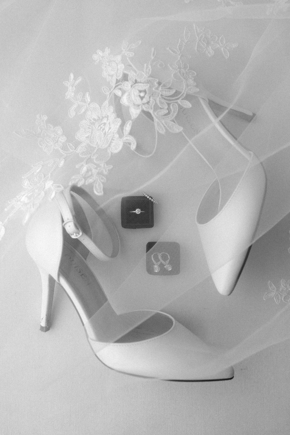 A series of white high heel shoes arranged in different angles on a light background showing artistic composition.