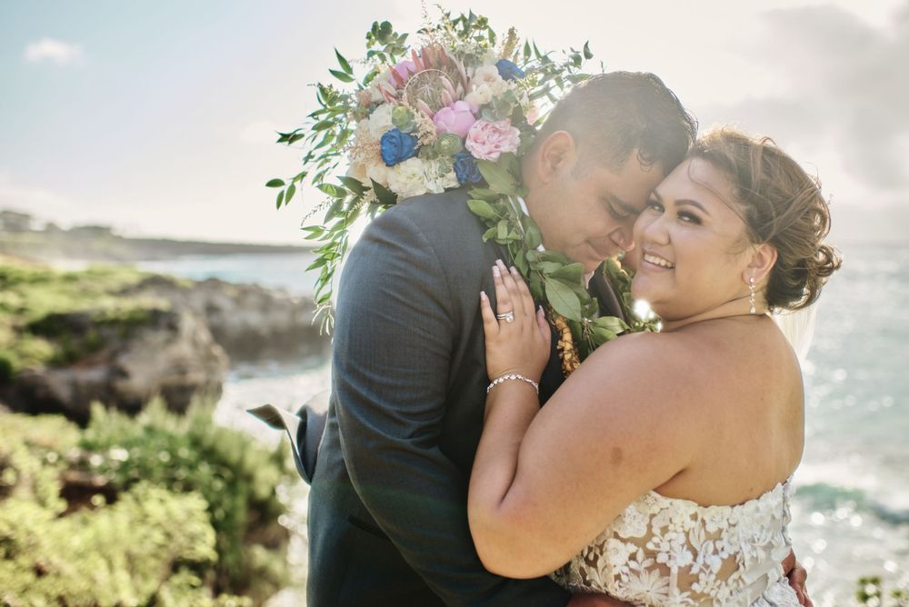 Romantic coastal wedding photos capture intimate moments against an ocean backdrop.