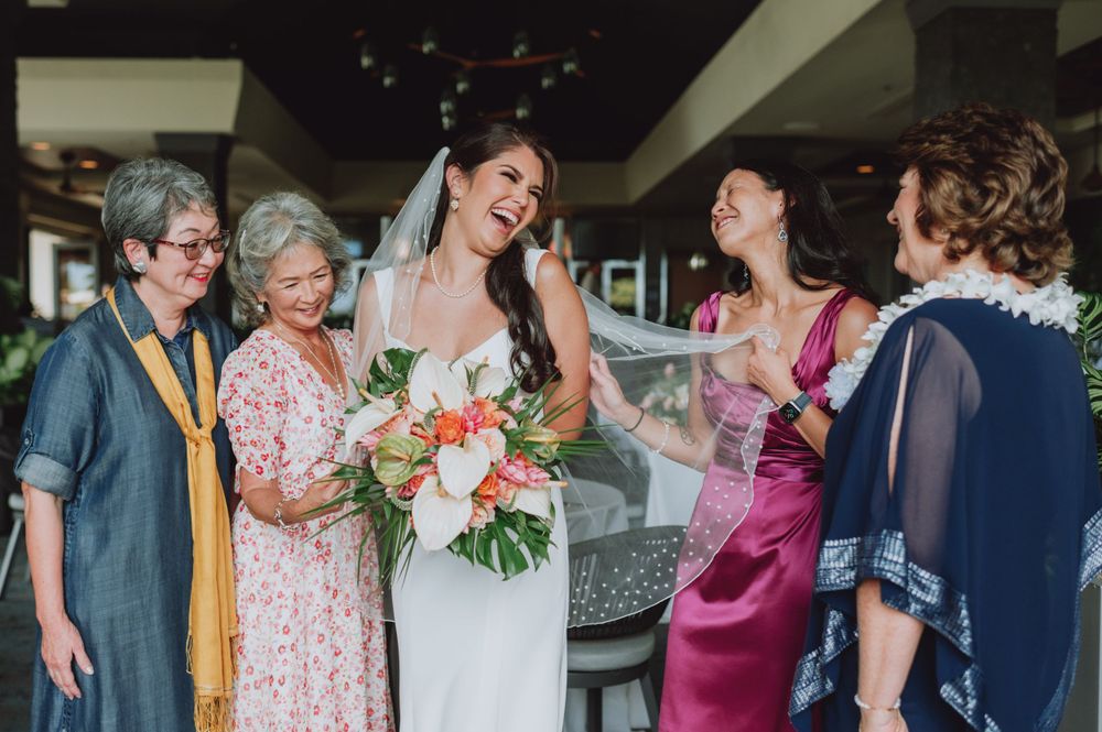 Indoor wedding reception scene with guests socializing in elegant venue space.