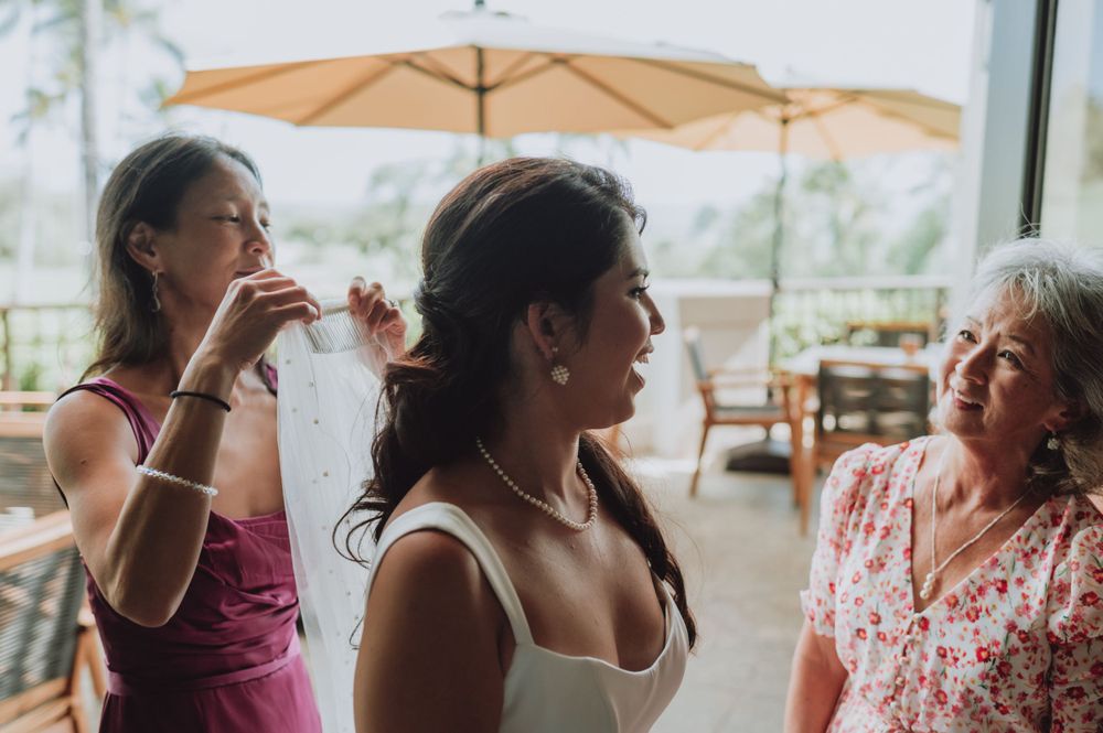 Wedding reception gathering with guests mingling under covered outdoor venue.