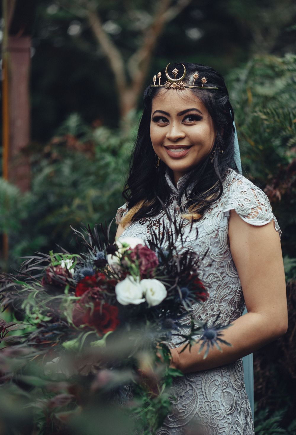 Wedding portraits showcasing detailed lace gown and dramatic floral bouquet in garden setting.