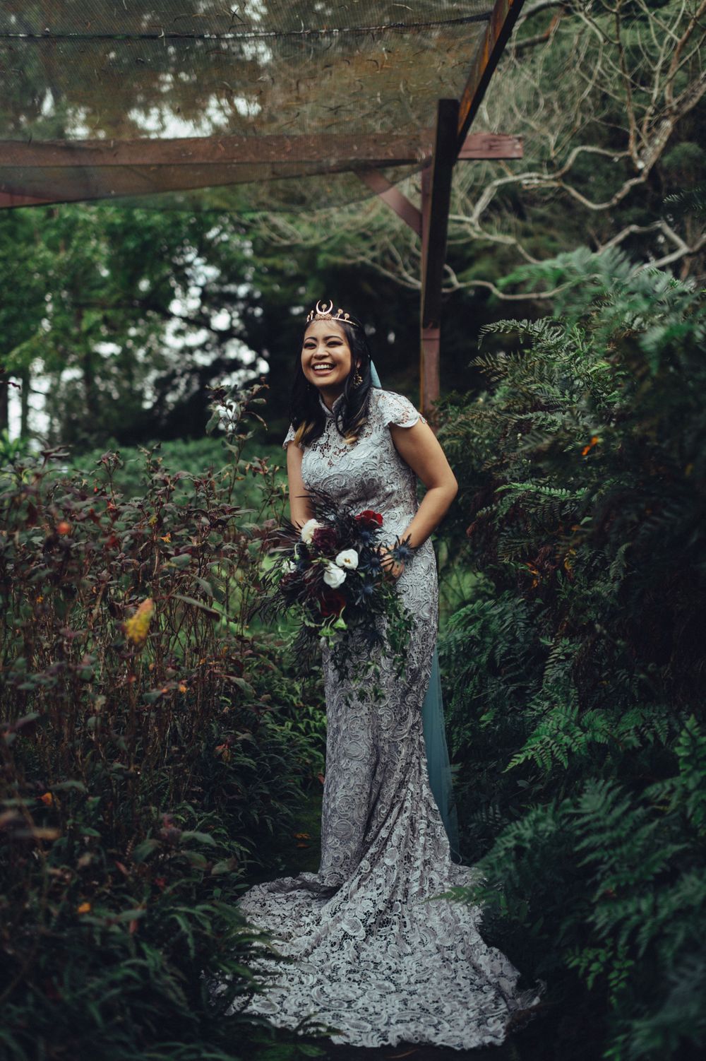 Full-length bridal portraits in a lace gown against a garden landscape.