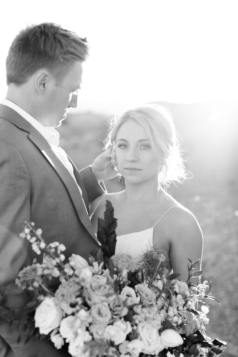Ethereal desert wedding portraits capture intimate moments between newlyweds in soft natural light.