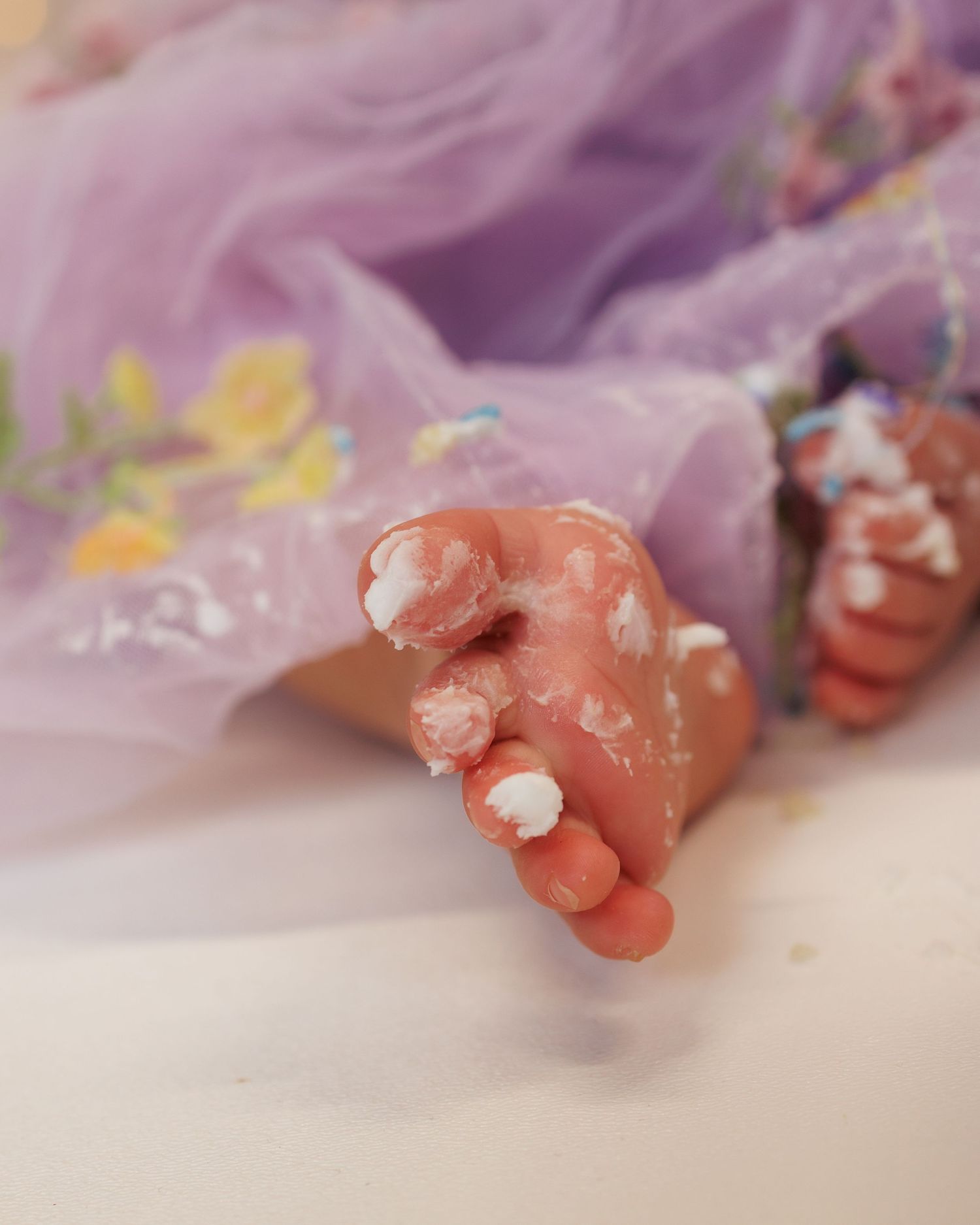 A sequence of five pink clay or putty objects in progressive states of deformation against a purple background.