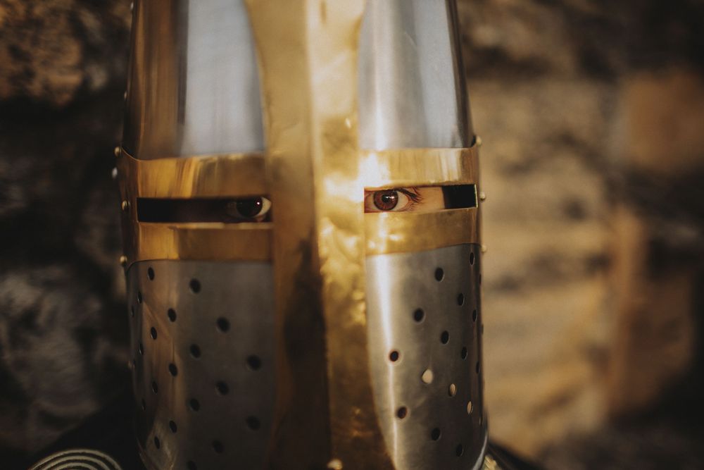 Cinematic detail shot of medieval armor with warm golden light, photographed in a moody storytelling style