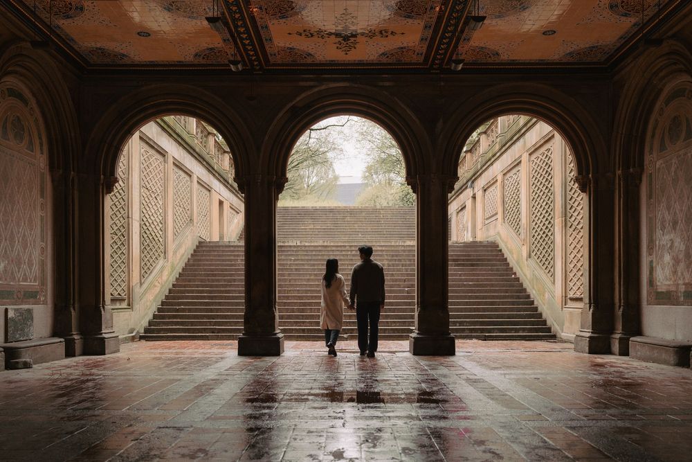 Historic stone archways and columns create a dramatic architectural backdrop.