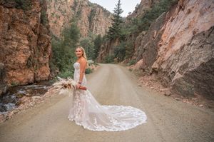 Rustic mountain road wedding photography with dramatic canyon walls.