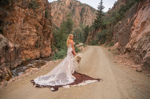 Scenic canyon road with elegant bridal portraits and natural rock formations.