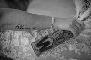Black and white detail shot of delicate lace patterns and tattoo artwork.