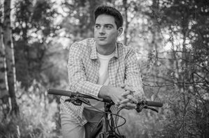 Black and white portraits with mountain bike in wooded setting.